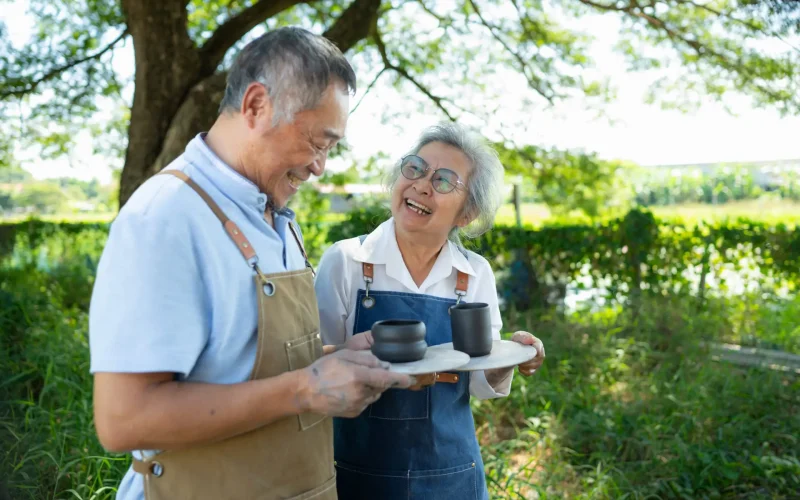 Portrait of a senior Asian couple doing activities together in t Portrait of a senior Asian couple doing activities together in the pottery workshop.